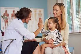Doctor giving high five to child